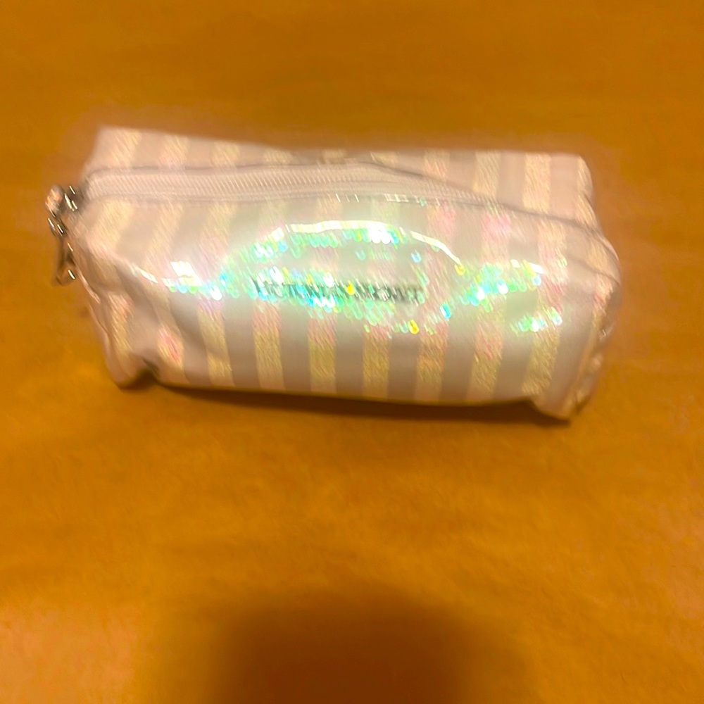 Women’s white sequin striped makeup bag by Victoria Secret.